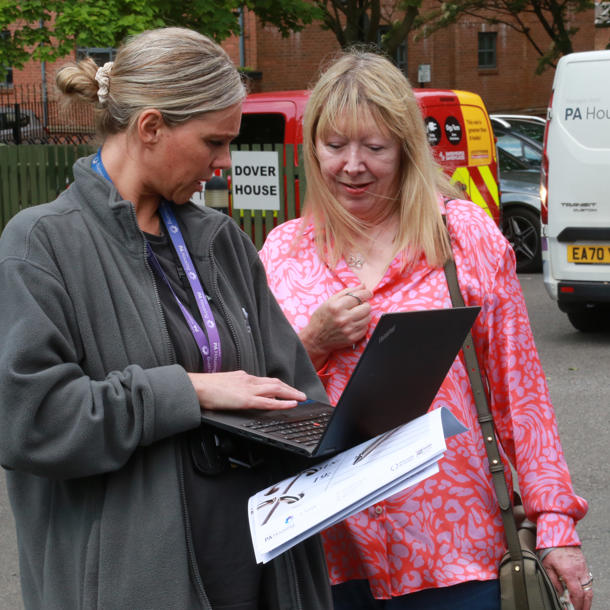 A person conducting a survey with a resident