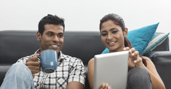 Asian couple using tablet - stock