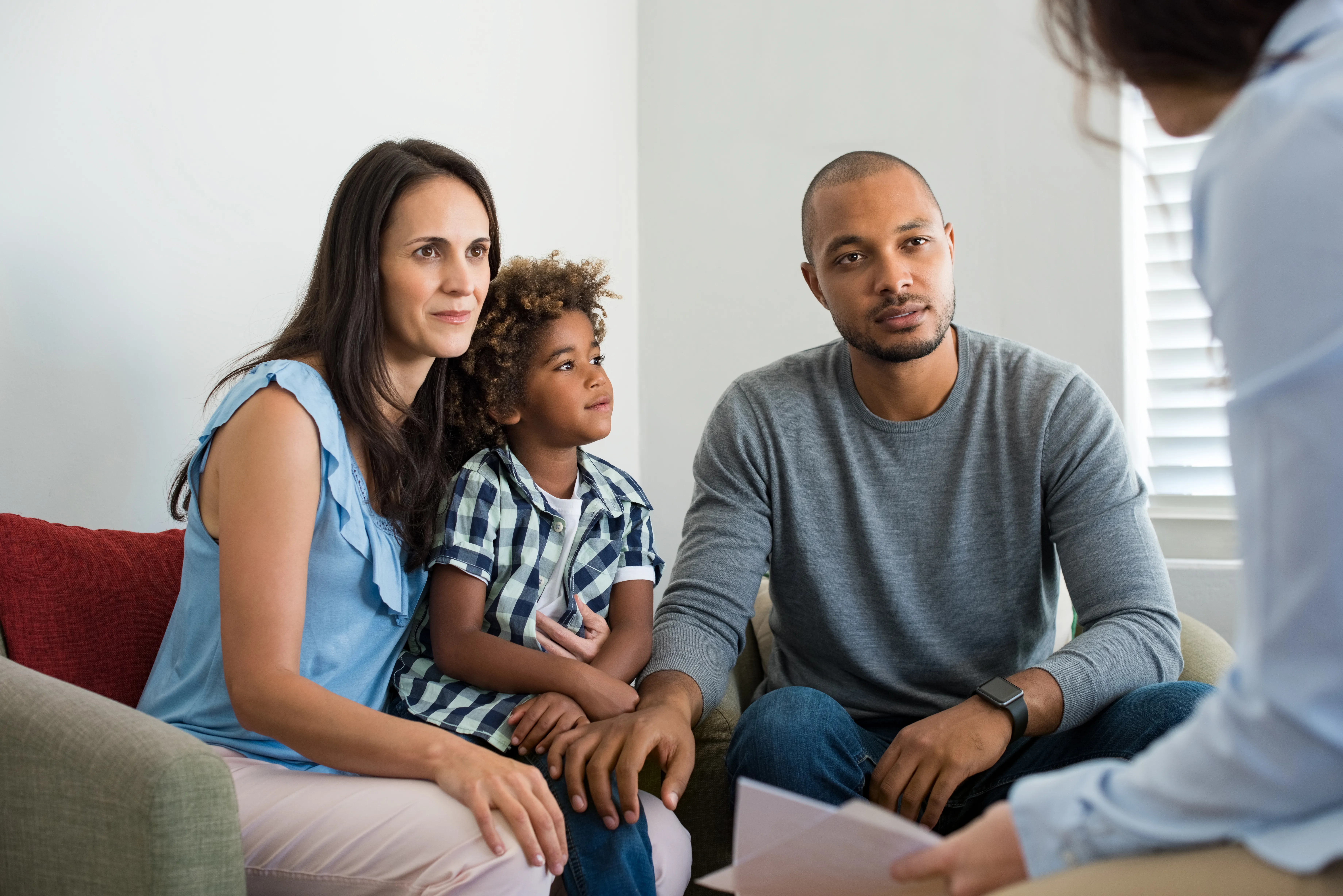 Family on sofa getting financial advice - stock