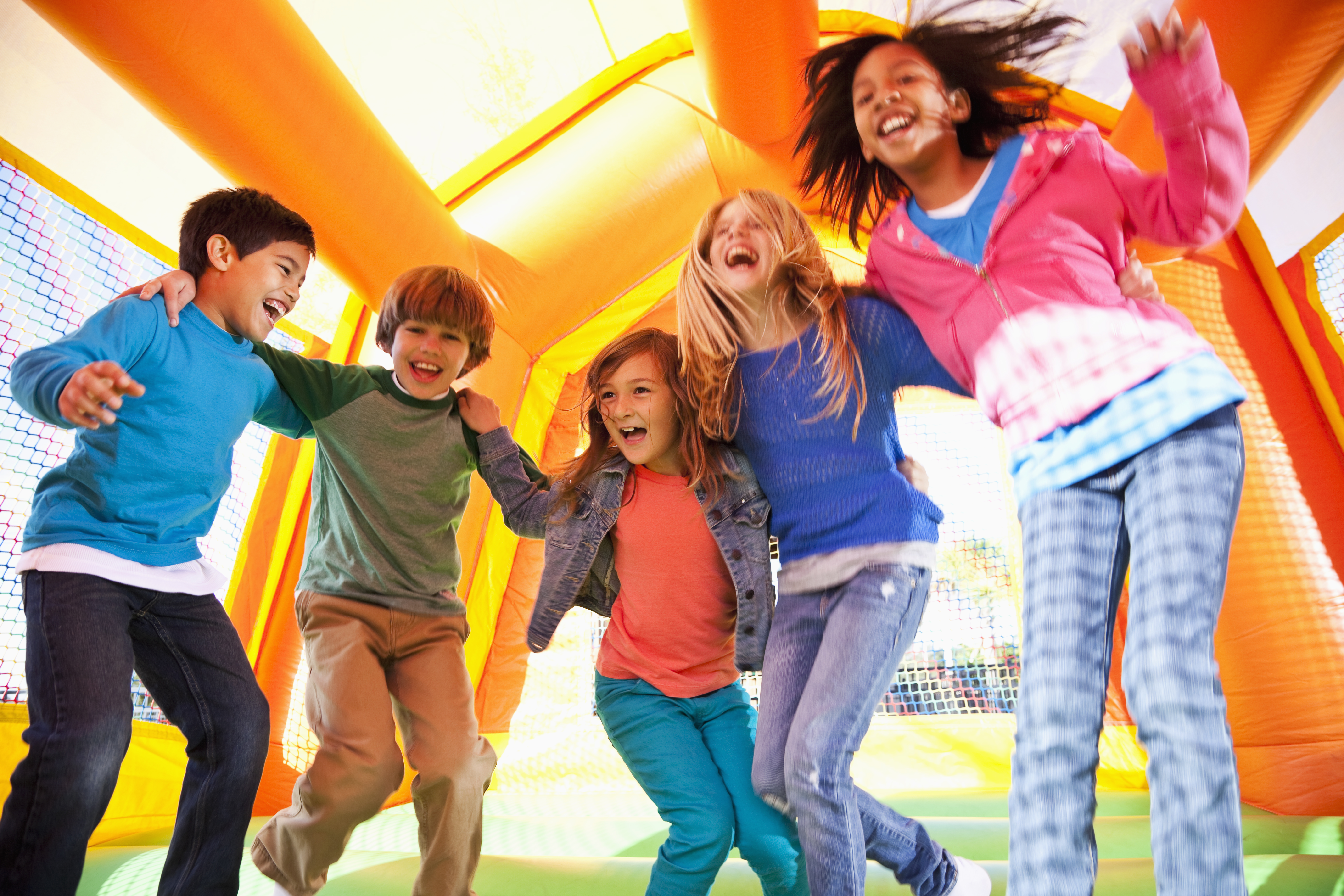 Children on bouncy castle - stock