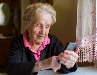 Elderly woman on smartphone - stock