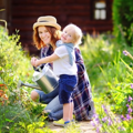Mum and child gardening - stock