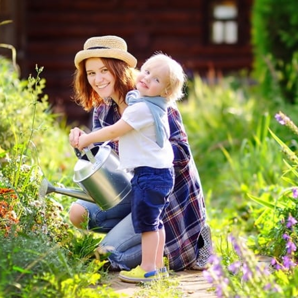 Mum and child gardening - stock