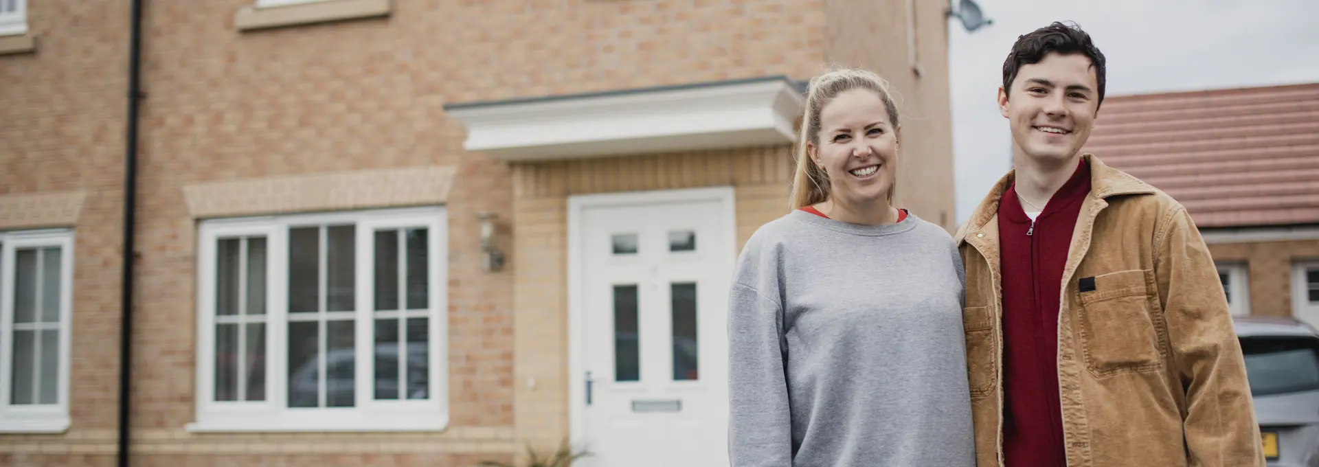 Couple outside new home - stock