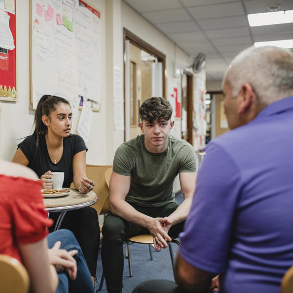 A group of 4 people, 2 women and 2 men sat down having a conversation