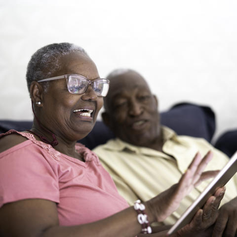 Older black couple using ipad - stock