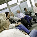 A group of people sat at a community meeting listening