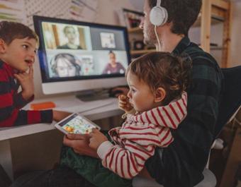 White father working from home with children