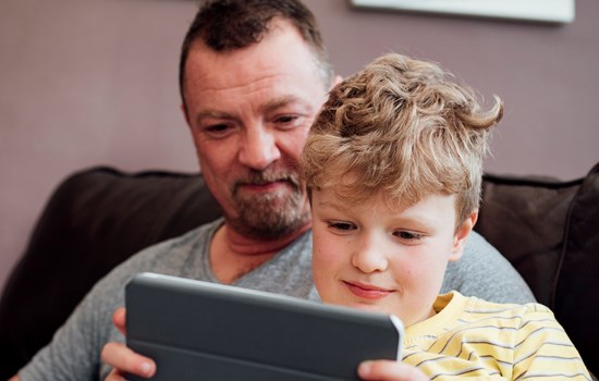 White father and son using ipad