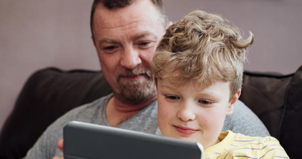 White father and son using ipad