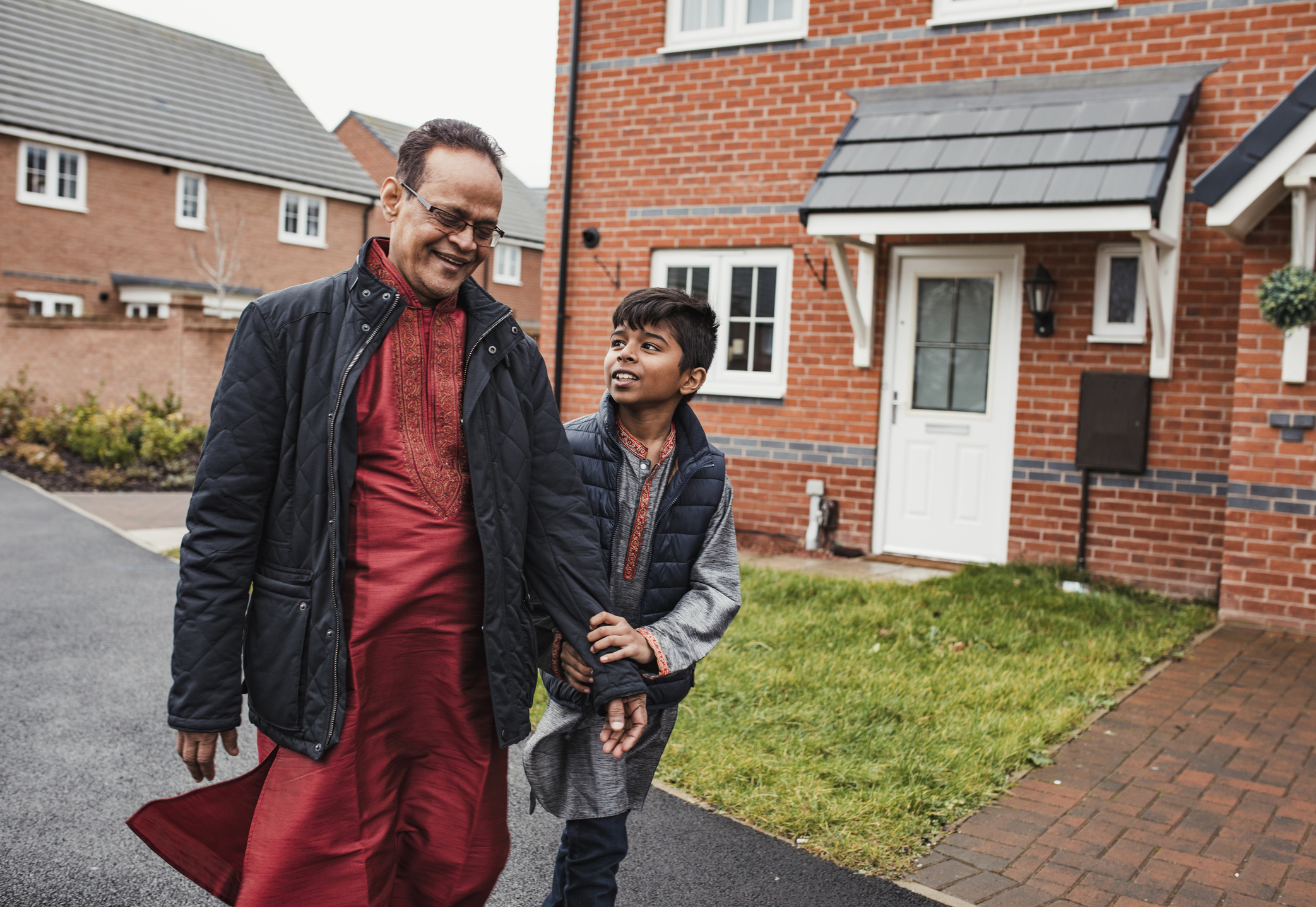 Muslim father and son walking down the road