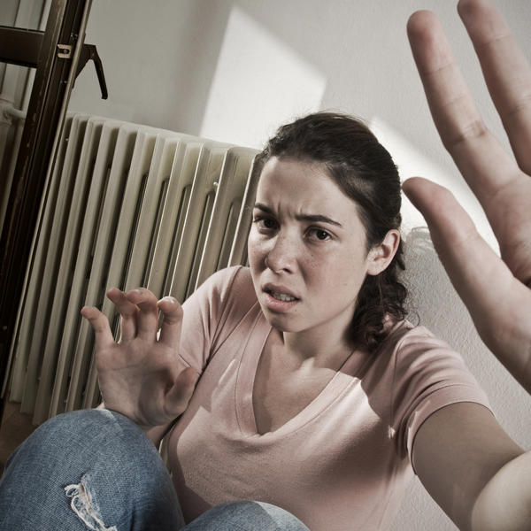 A picture of a woman cowering away from the camera