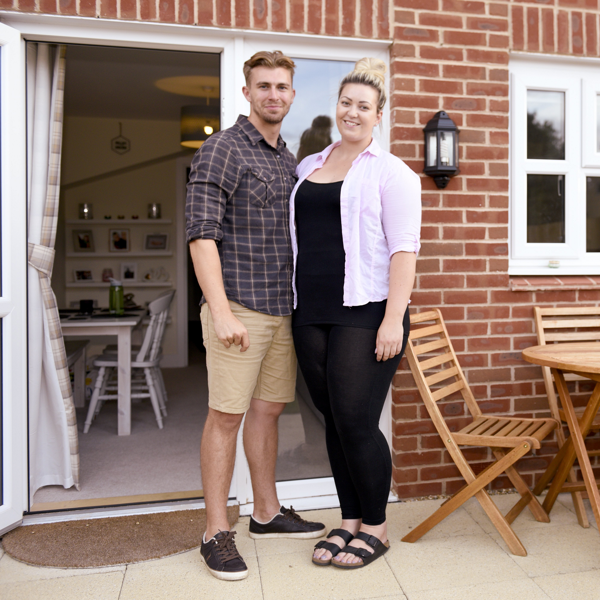 Young couple outside their back door