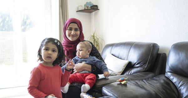 A Muslim mother and children on the sofa