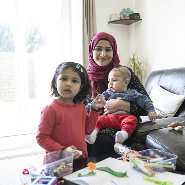 A Muslim mother and children on the sofa