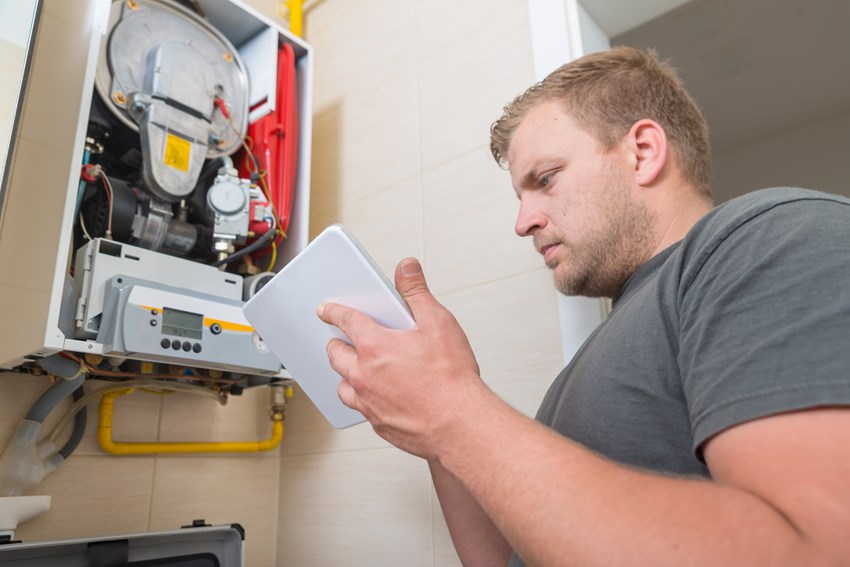 Image of gas engineer servicing a boiler