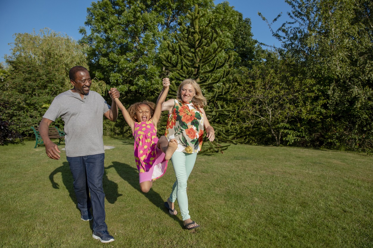 Family Playing In The Sunshine - stock