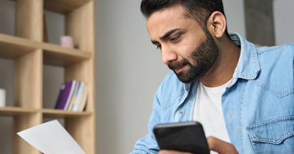 Indian Man Checking Details - stock