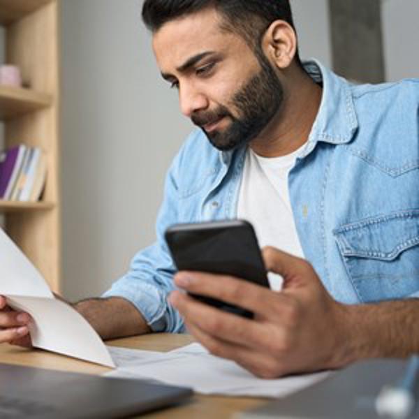 Indian Man Checking Details - stock