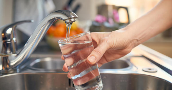 Pouring Fresh Tap Water Into a Glass stock photo