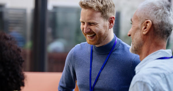 Smiling business man talking to his colleagues
