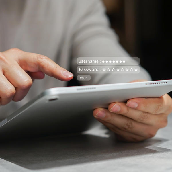 Close up employee man hand type password on digital tablet