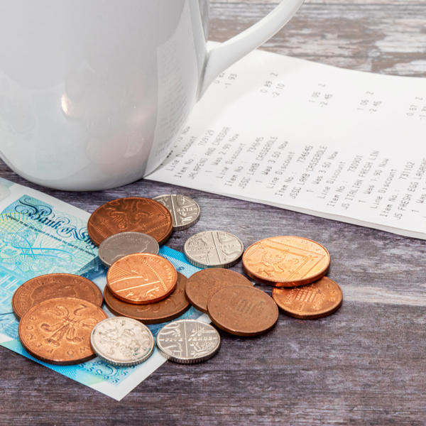 Shopping receipt with some coins and banknote