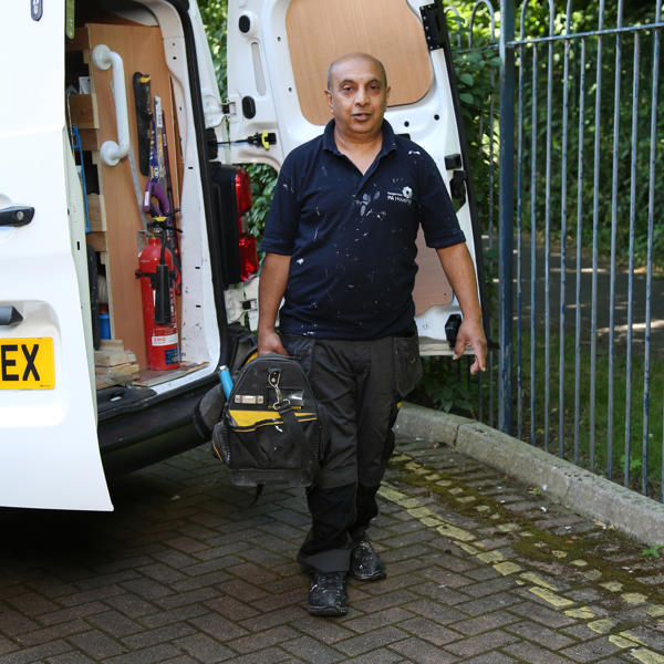 A person carrying a toolbox