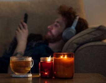Man On Sofa With Candles