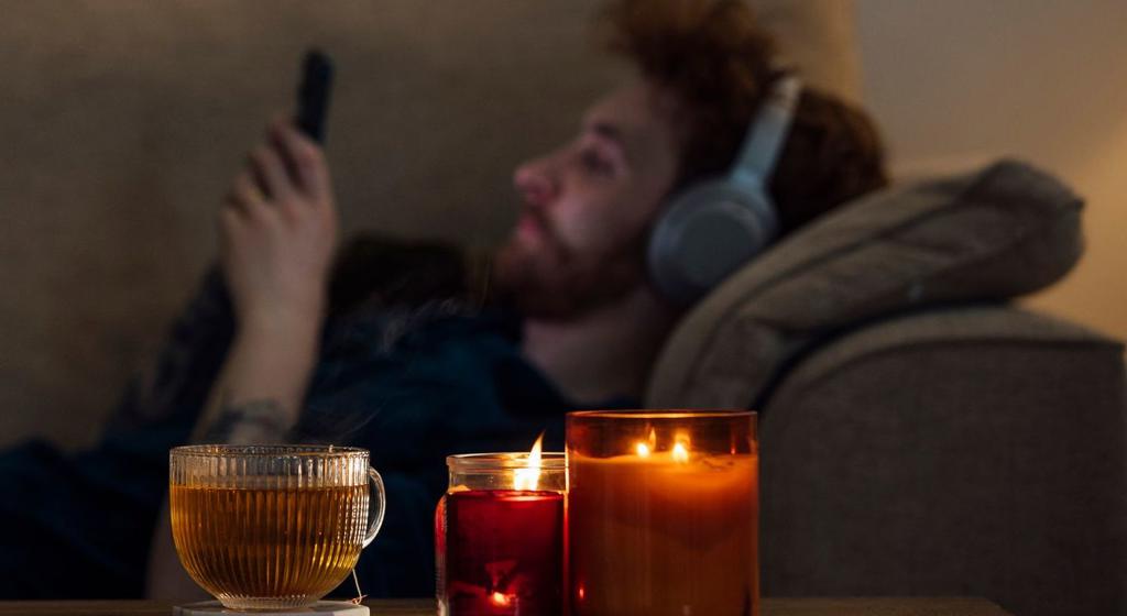 Man On Sofa With Candles