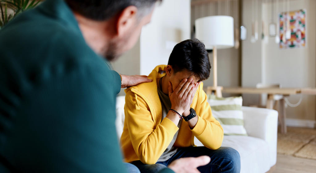 Worried Man Being Comforted By A Colleague