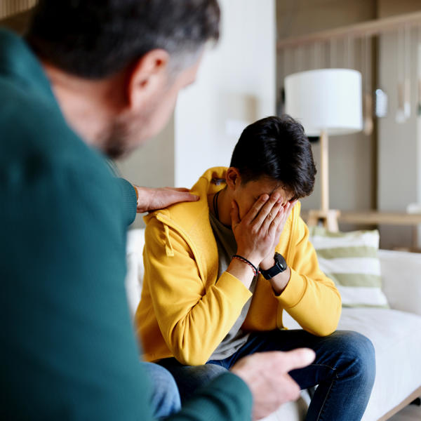 Worried Man Being Comforted By A Colleague