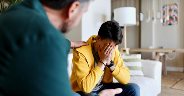 Worried Man Being Comforted By A Colleague