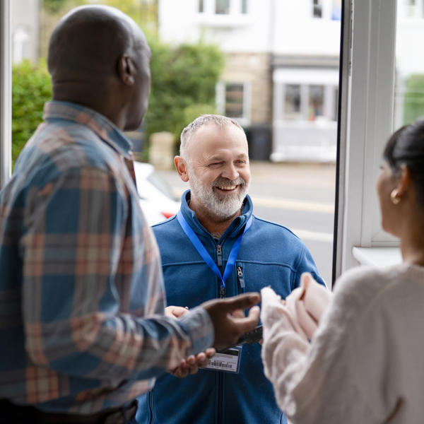 People Talking In Doorway In A Bright Setting During Daytime
