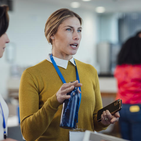 Women at work speaking with colleagues