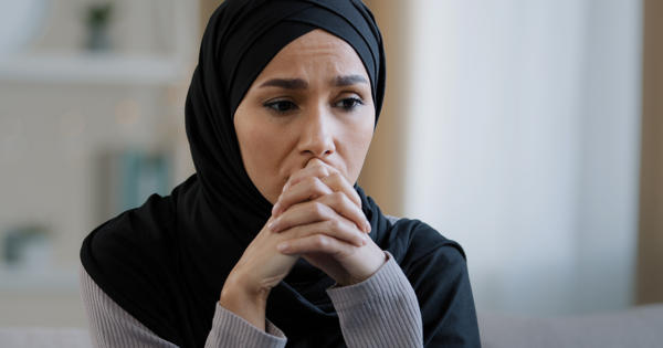 Upset sad girl in hijab sit alone