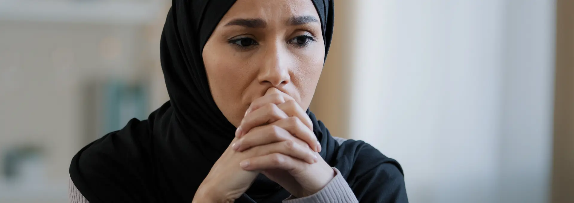 Upset sad girl in hijab sit alone