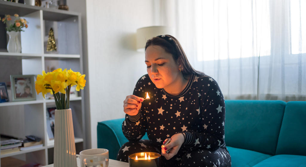 Woman lighting candle