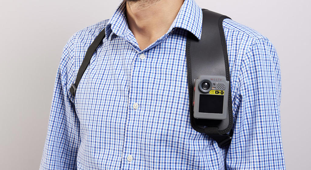Man in blue check shirt wearing a body worn camera